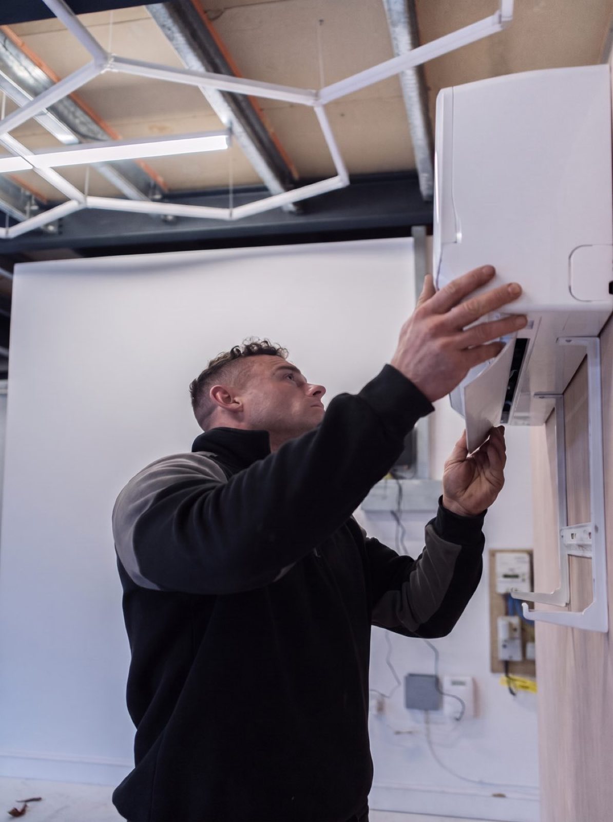 Ryan servicing an air conditioning system